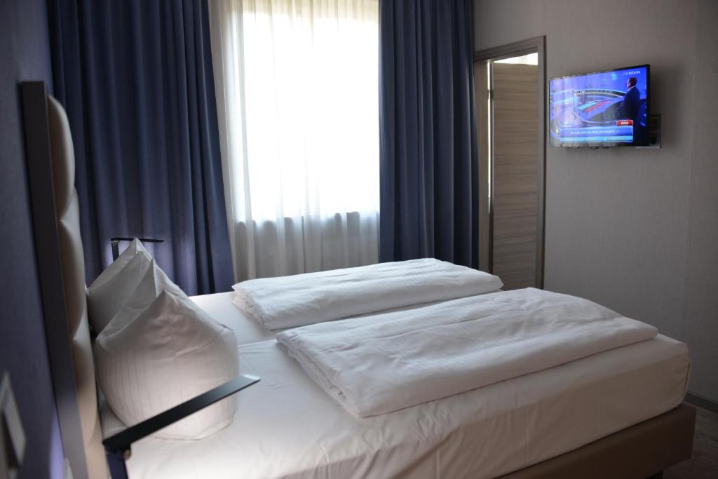 Postel nebo postele na pokoji v ubytování Belle Blue Zentrum