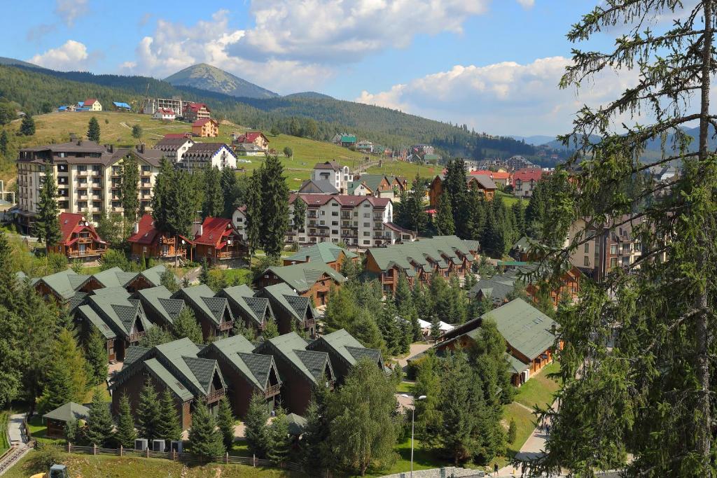 an aerial view of a town with houses and trees at Bukovel Hotel in Bukovel