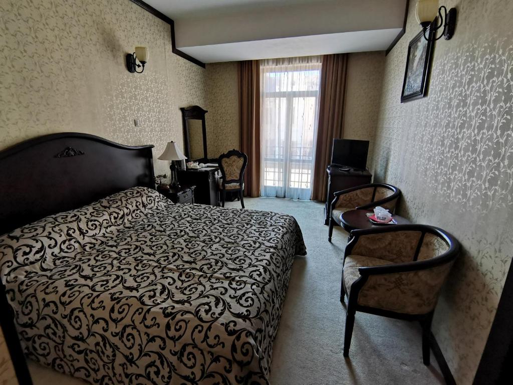 Кровать или кровати в номере Hotel Carol