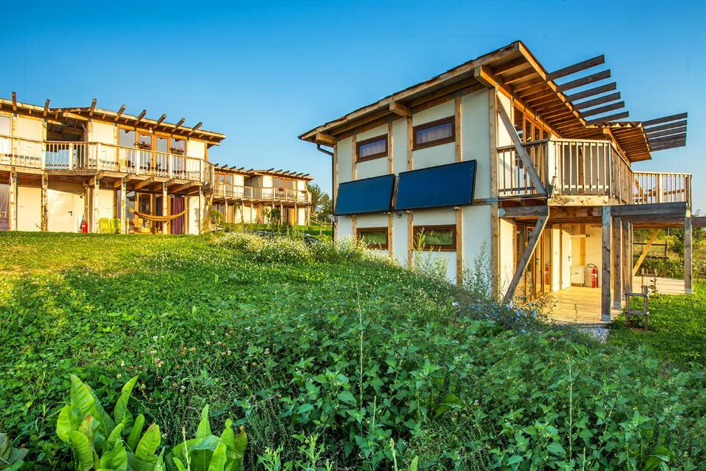 a group of houses on a grassy hill at Debeli Dab in Stara Kresna