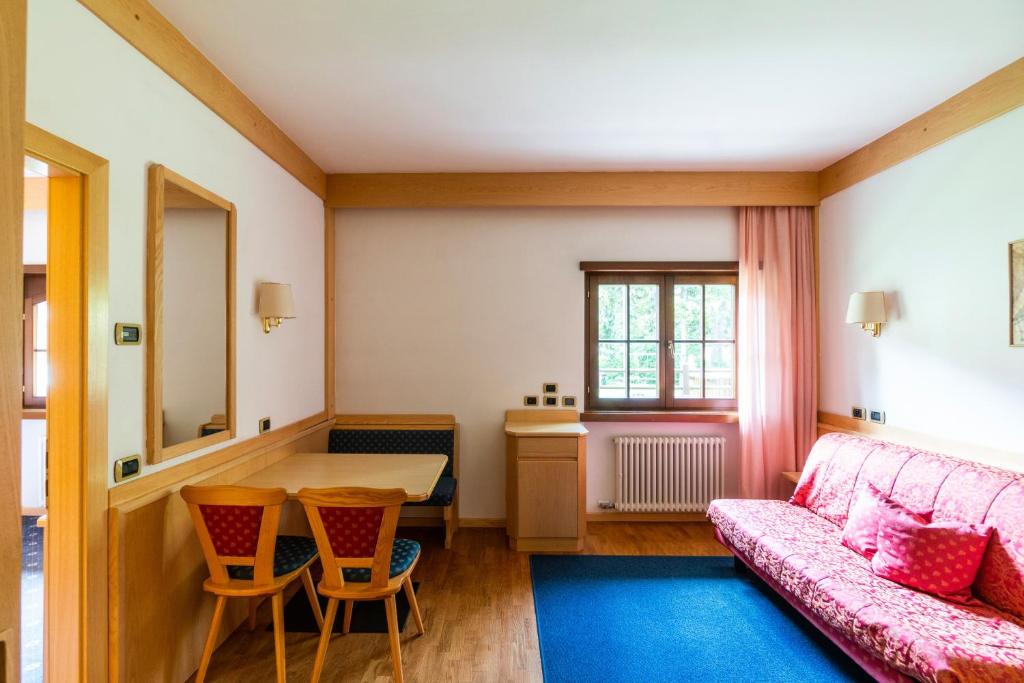 a living room with a couch and a table at Garni Aritz in Campitello di Fassa