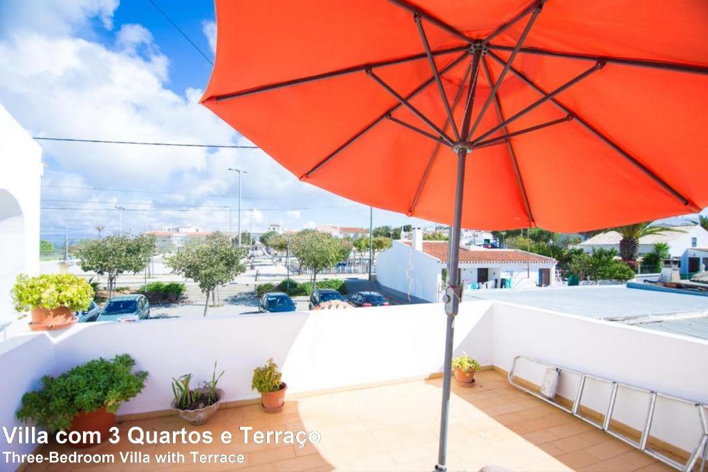 a red umbrella sitting on top of a balcony at Akivillas Lagos Beach III in Lagos