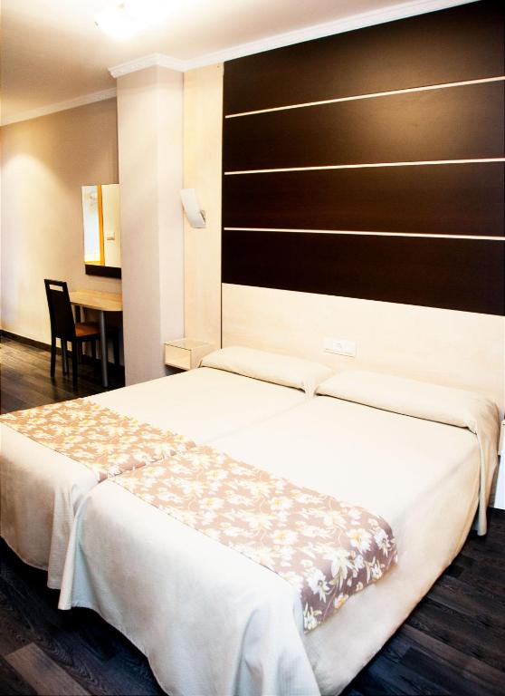 Postel nebo postele na pokoji v ubytování Hotel Universal