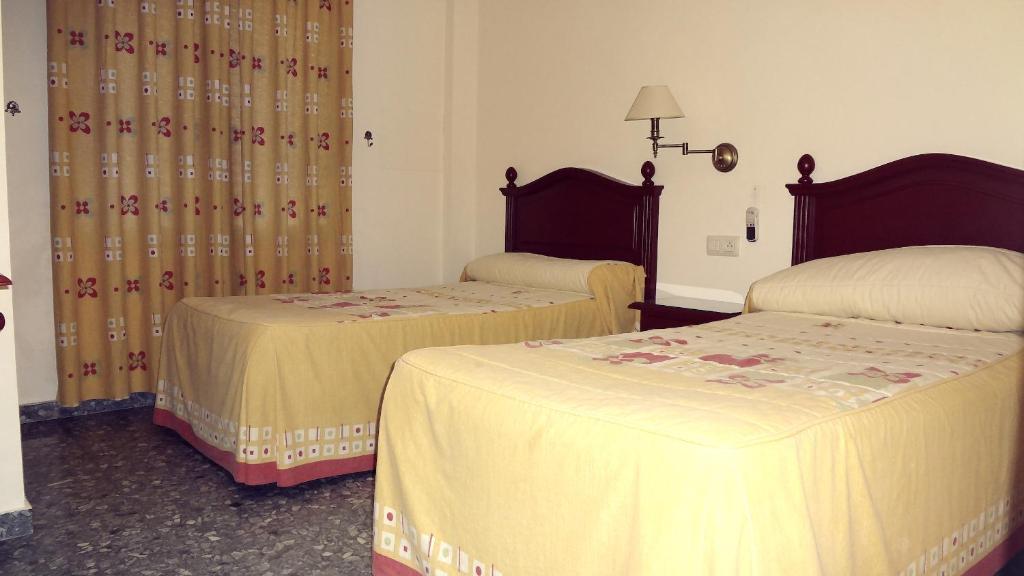 Postel nebo postele na pokoji v ubytování Hostal el Volao