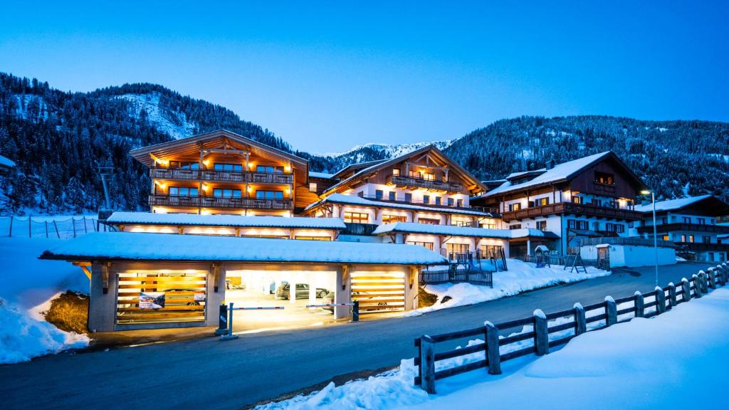 a lodge in the mountains in the snow at night at Tillga Glück - 4 stars in Obertilliach