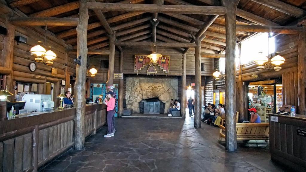 a woman standing at a bar in a restaurant at Bright Angel Lodge - Inside the Park in Grand Canyon Village