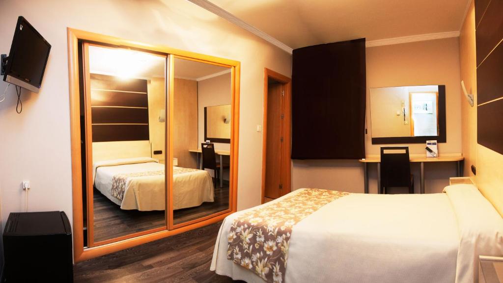 Postel nebo postele na pokoji v ubytování Hotel Universal