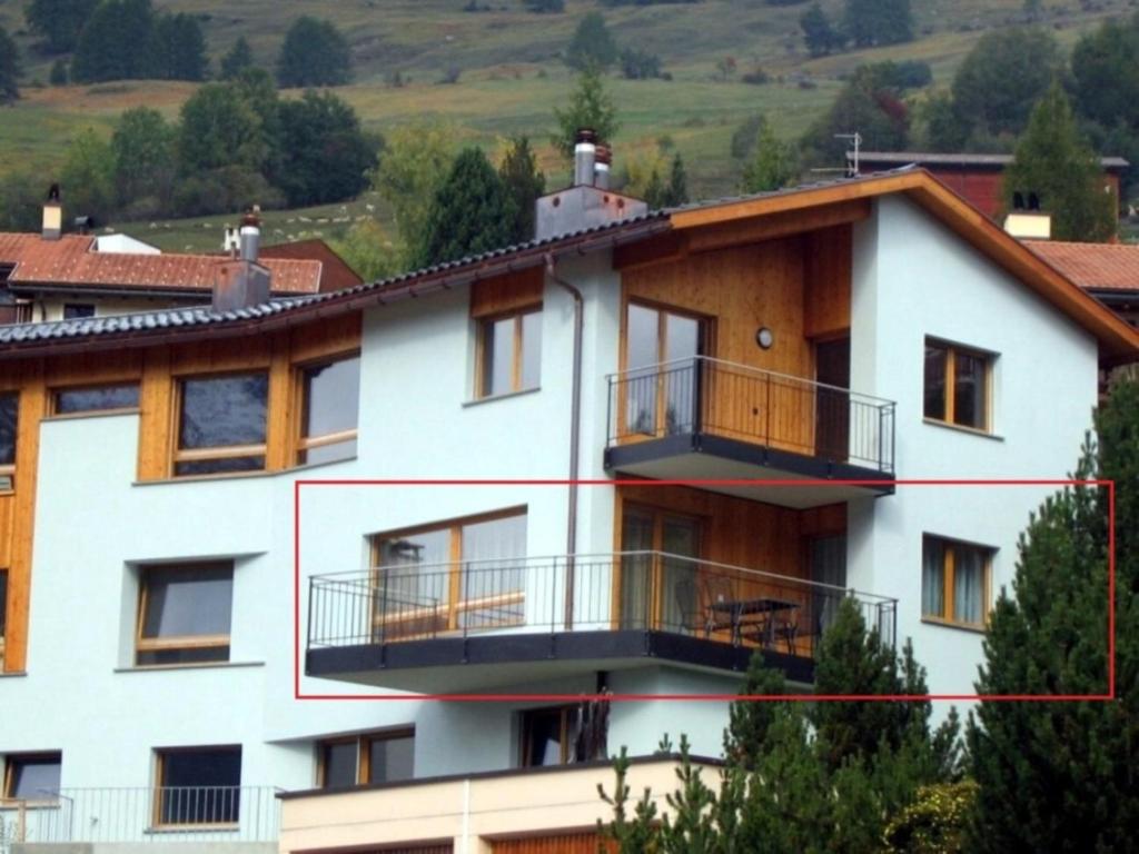 a house with balconies on the side of it at Chasa Azura in Scuol