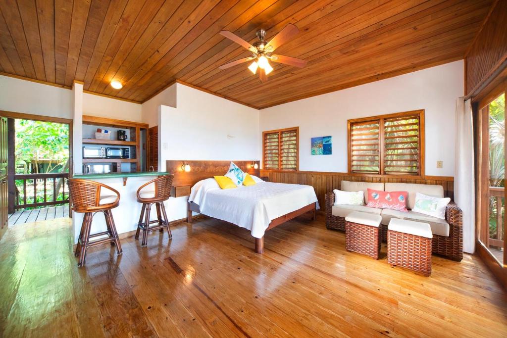 a bedroom with a bed and a table at Cocolobo Resort in West End