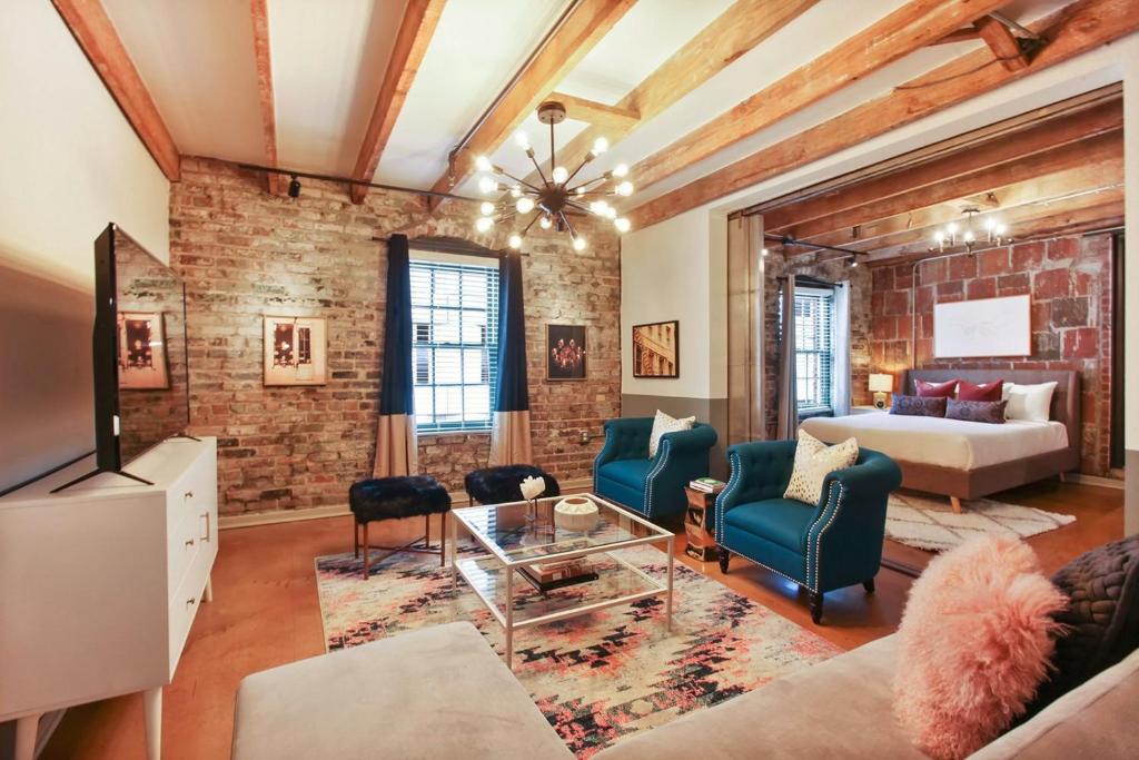 a living room with a brick wall at LiivUP Warehouse Apartments in New Orleans