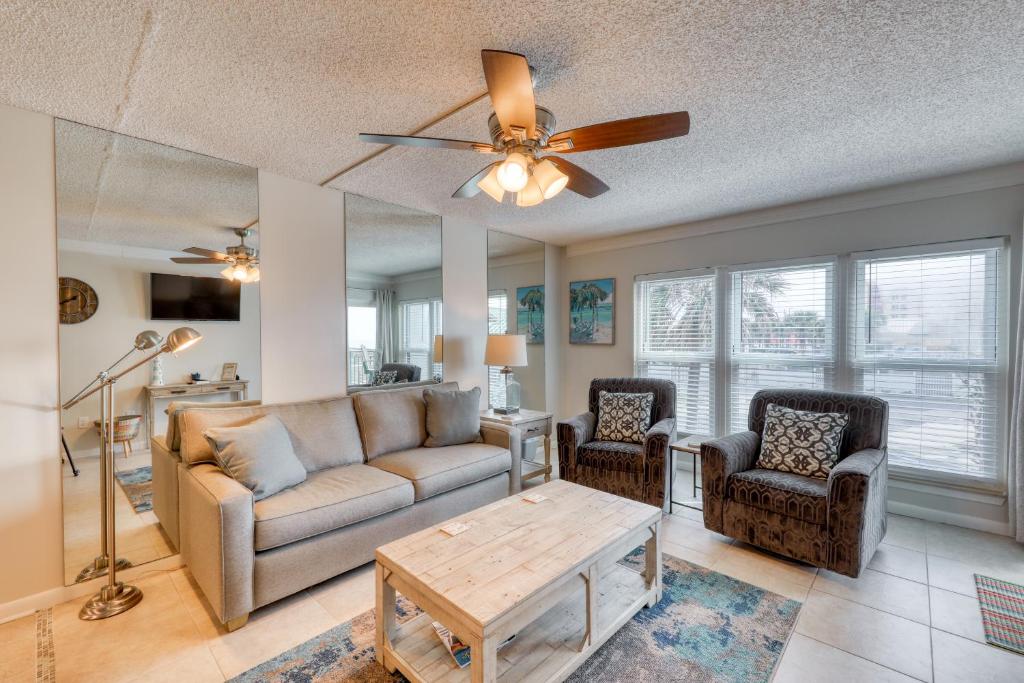 a living room with a couch and chairs and a ceiling fan at Emerald Isle in Fort Walton Beach