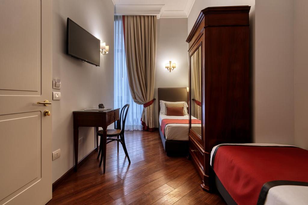 Postel nebo postele na pokoji v ubytování Decumani Hotel De Charme