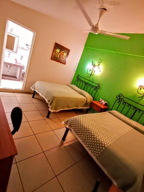 Postel nebo postele na pokoji v ubytování Hotel Posada Santo Niño