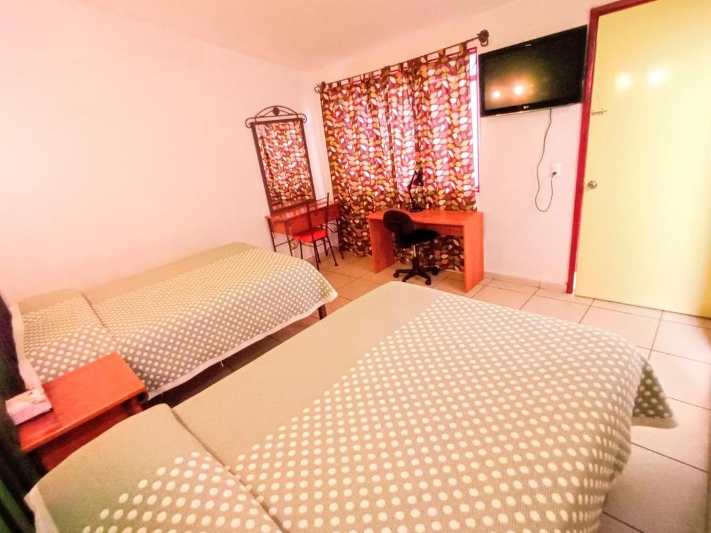 Postel nebo postele na pokoji v ubytování Hotel Posada Santo Niño