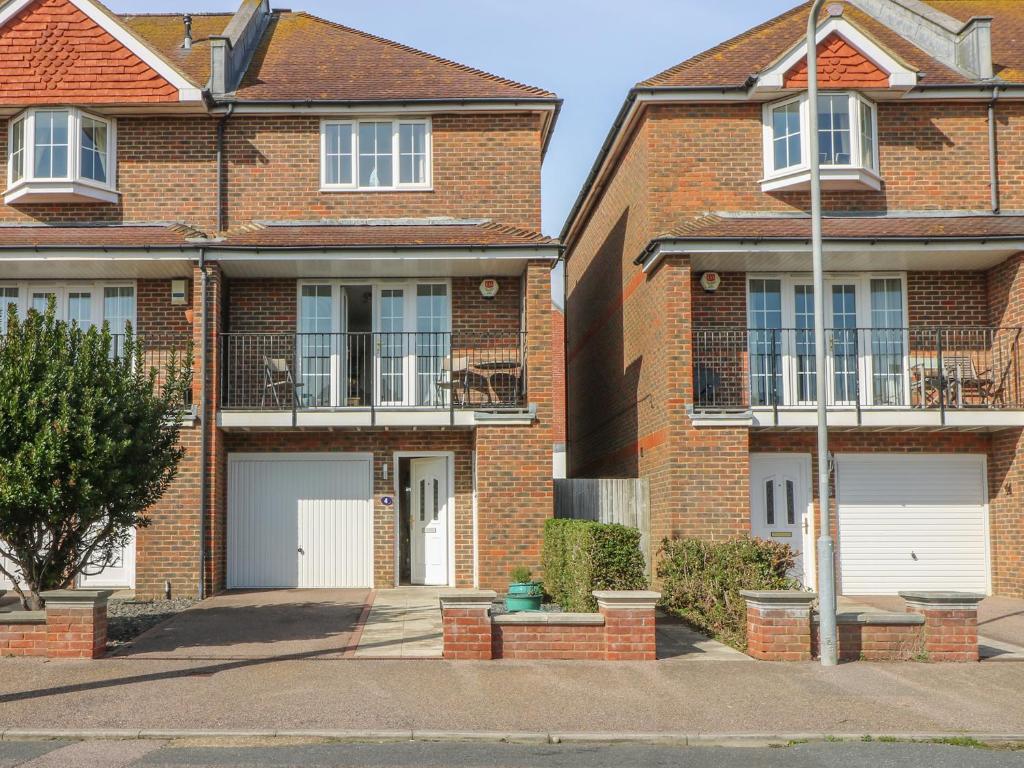 a brick house with two garages at Seascape in Bexhill