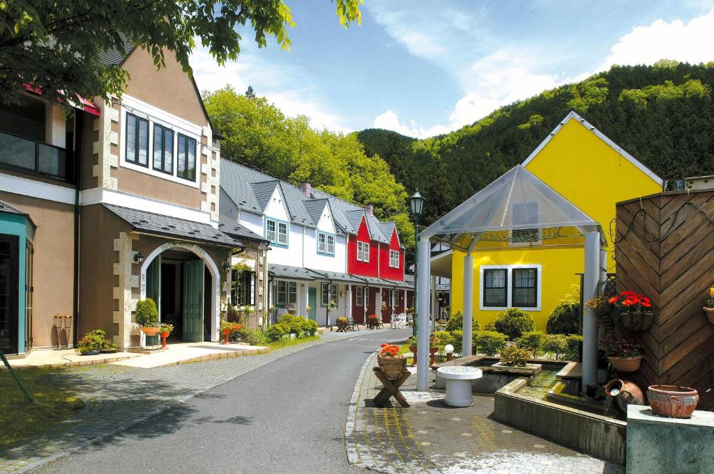 a street in a town with colorful houses at Hotel Euro City in Nikko