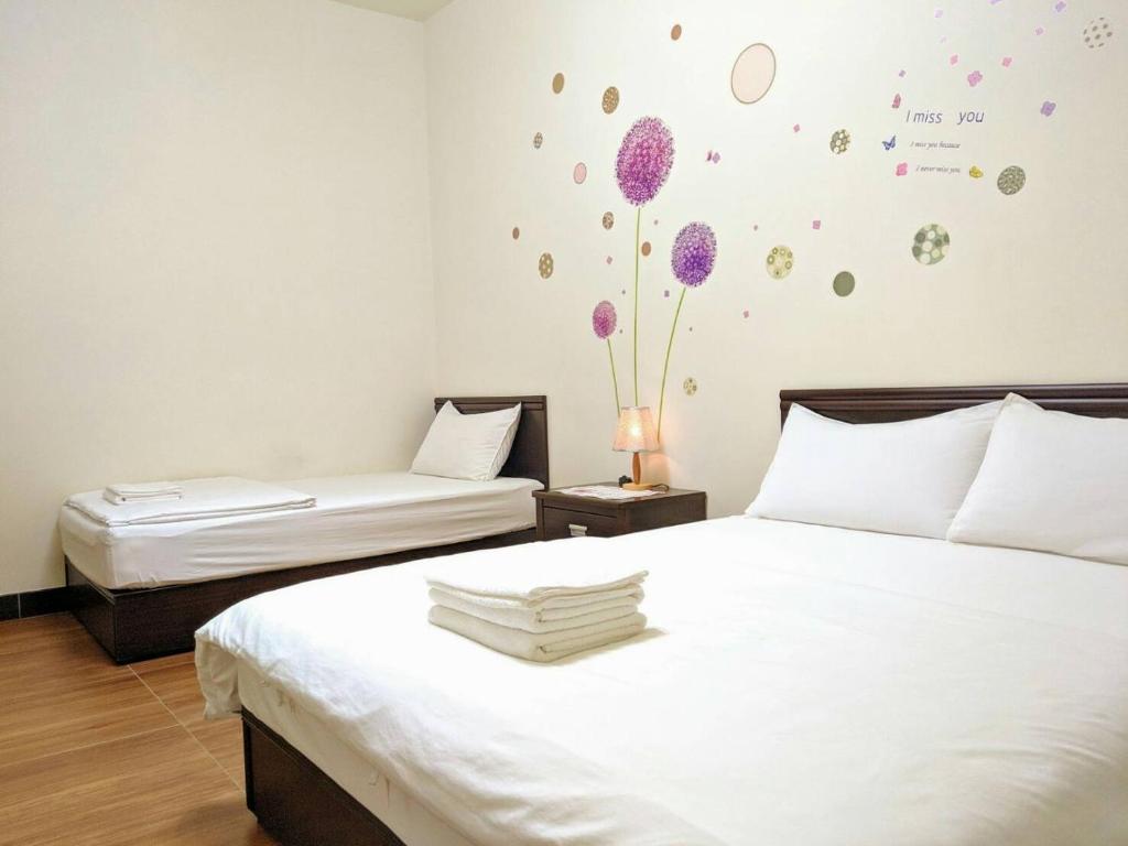 Postel nebo postele na pokoji v ubytování Jin Xi Fu B&B