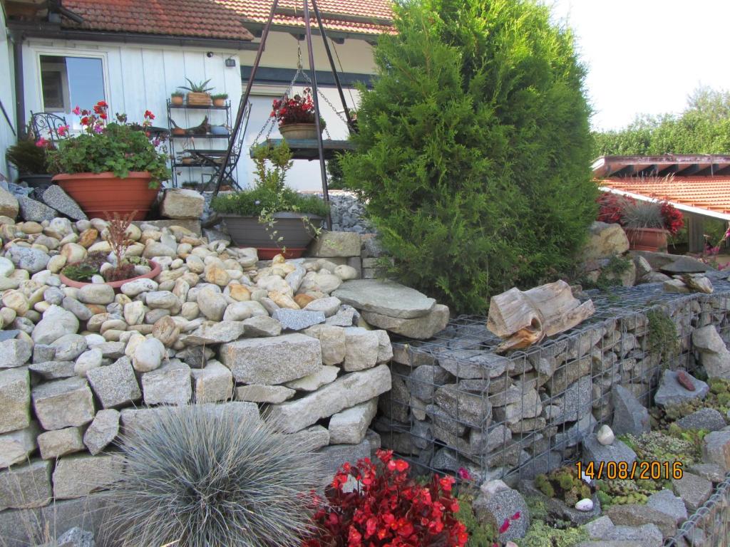 a rock retaining wall in front of a house at Apartment für zwei in Neukirchen vorm Wald