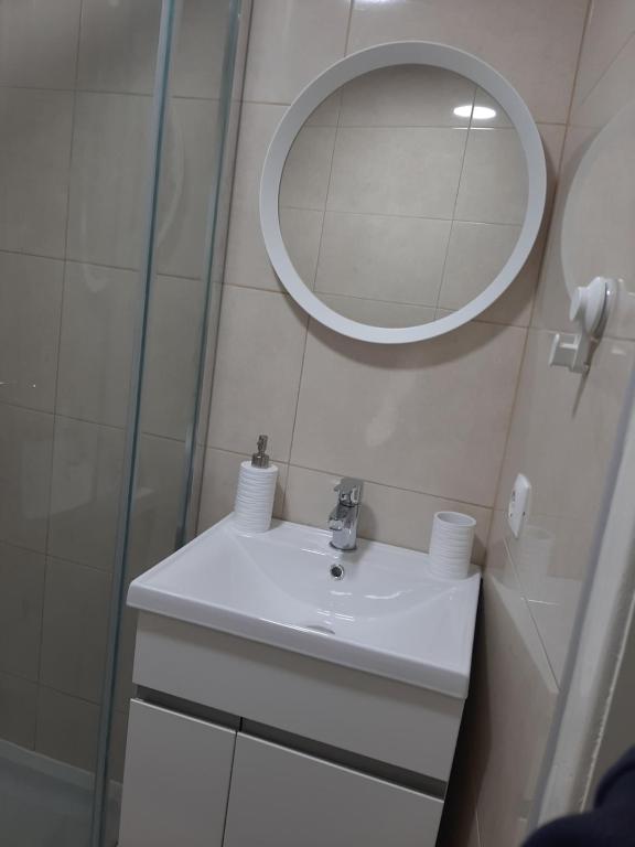 a bathroom with a sink and a mirror at Casa Beco Do Castelo in Lisbon