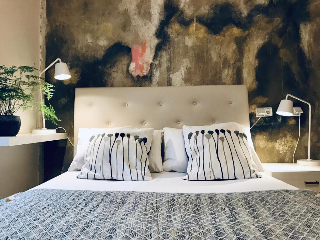 a bedroom with a white bed with two pillows at Lekkerurlaub in Berlin