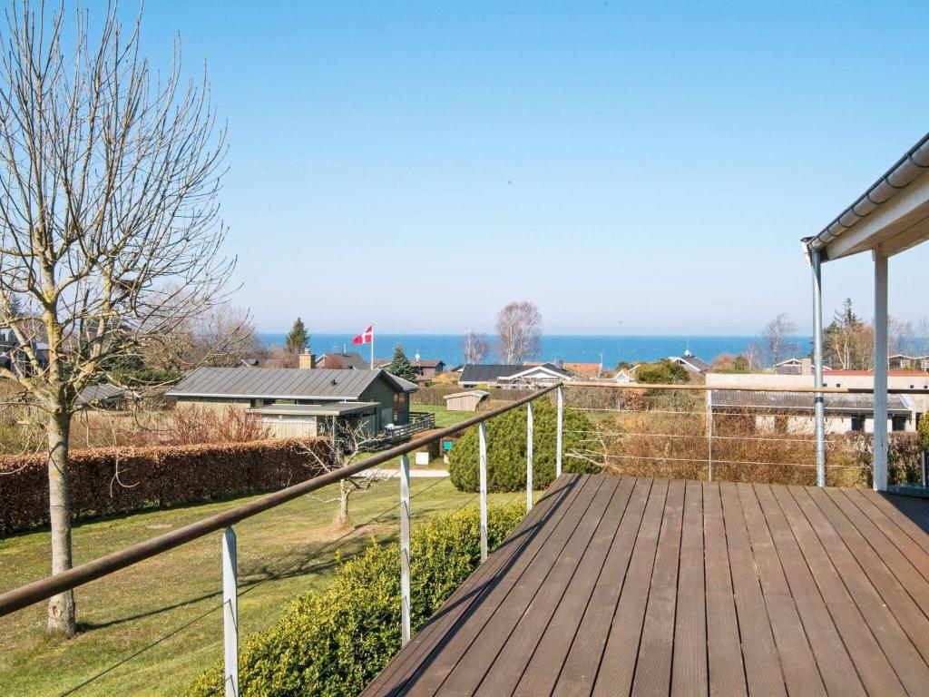 a wooden deck with a view of the ocean at 6 person holiday home in Alling bro in Rygård Strand