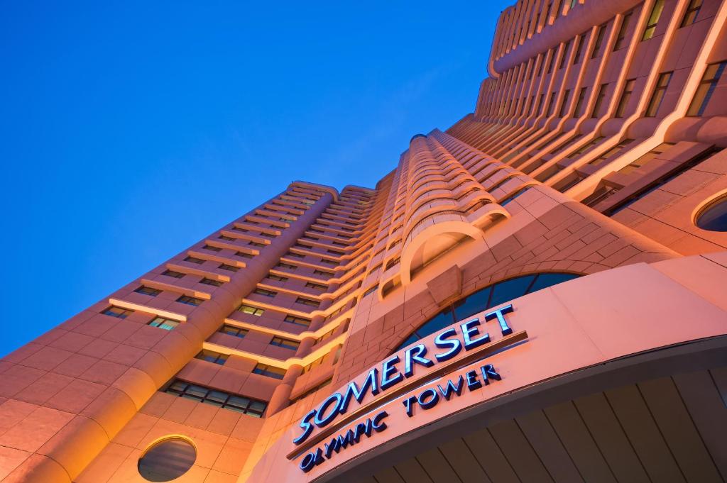 a building with a sign on the side of it at Somerset Olympic Tower Tianjin in Tianjin