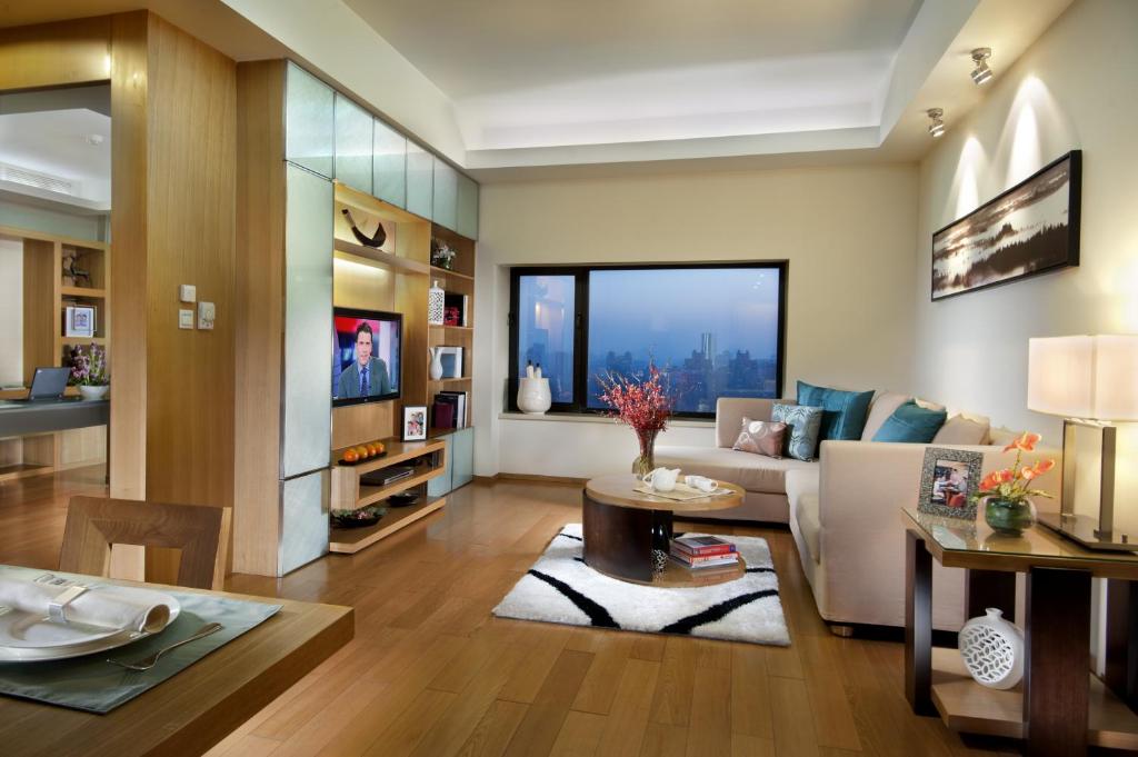 een woonkamer met een bank en een tafel bij Somerset International Building Tianjin in Tianjin