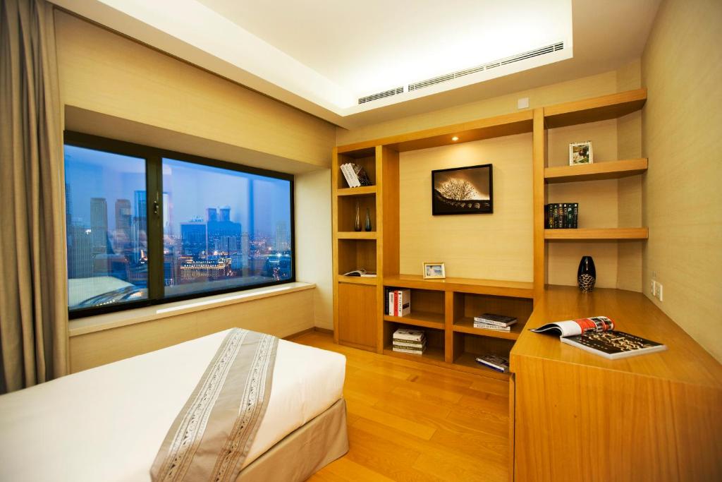 Postel nebo postele na pokoji v ubytování Somerset International Building Tianjin