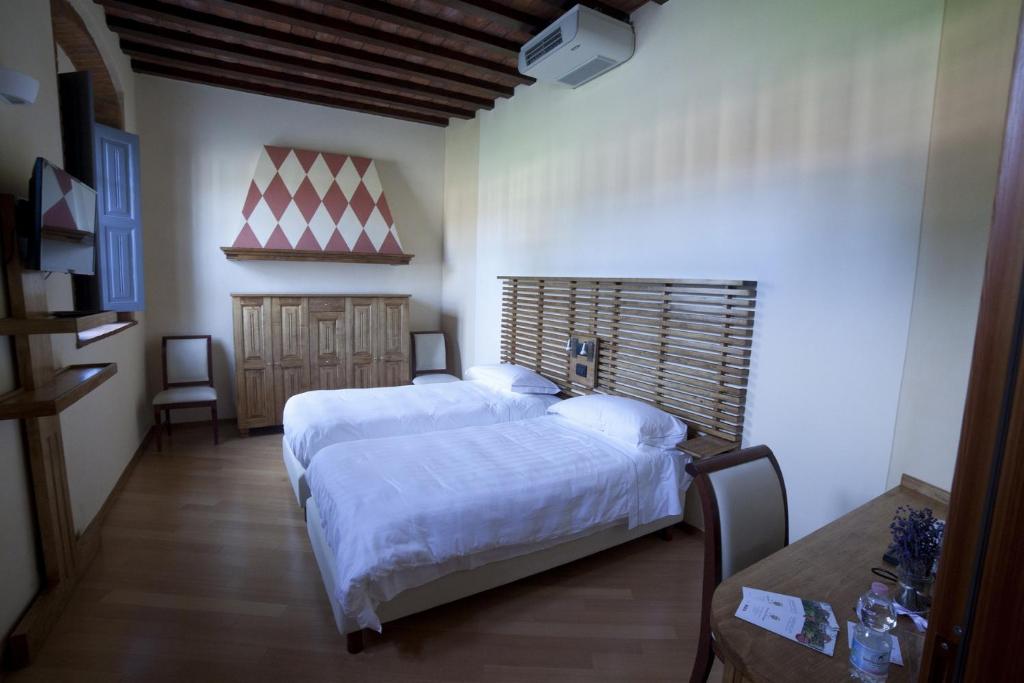 Postel nebo postele na pokoji v ubytování Agriturismo Cascina Farisengo