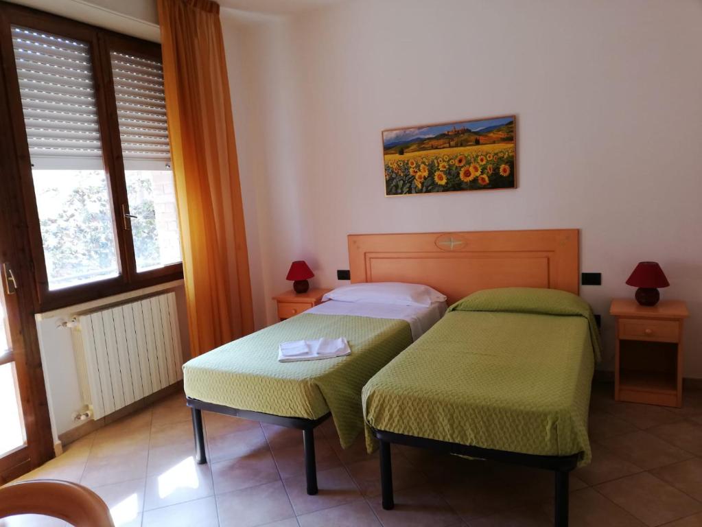 Кровать или кровати в номере Le Coltie - affittacamere e appartamenti