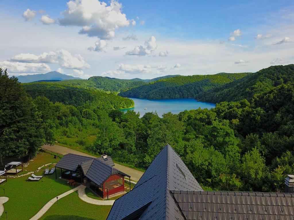 an aerial view of a house with a view of a lake at Etno Garden Exclusive Rooms in Plitvica Selo