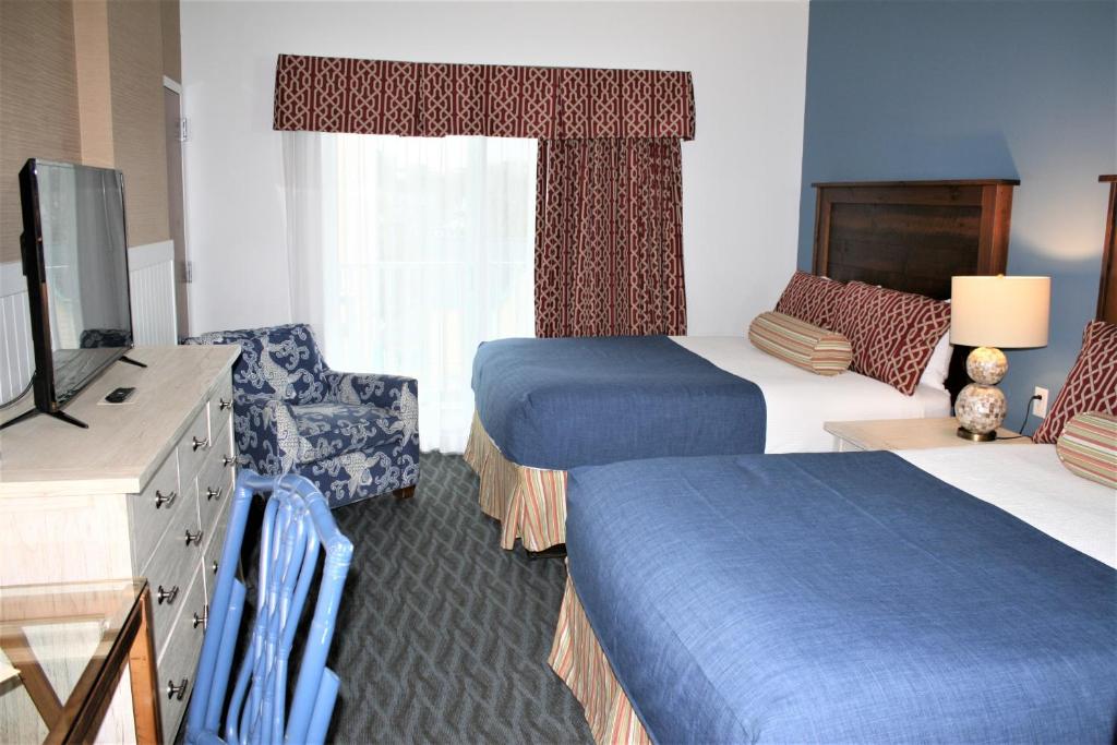 a hotel room with two beds and a television at Avenue Inn & Spa in Rehoboth Beach