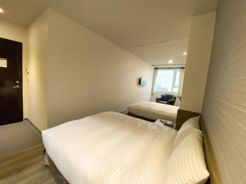 Postel nebo postele na pokoji v ubytování Hotel Brown - Zhongzheng