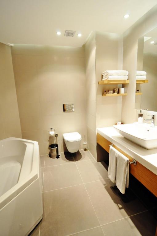 a bathroom with a sink and a toilet and a tub at Silivri Park Hotel in Silivri