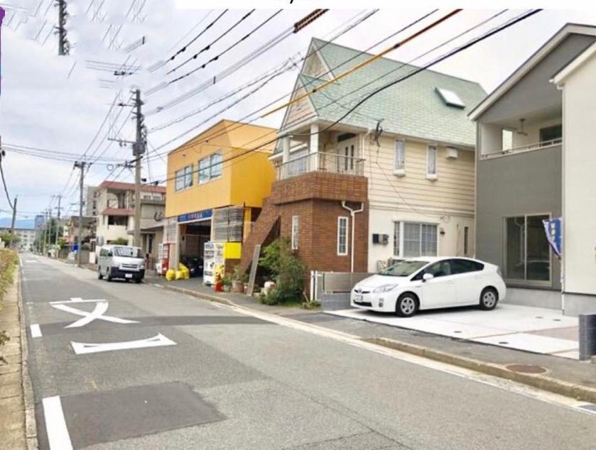 a white car parked on the side of a street at 福恵館 in Fukuoka