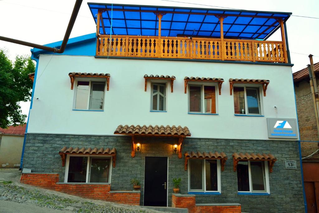 a house with a balcony on top of it at Hotel Formula-1 in Tbilisi City