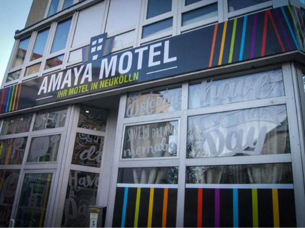 a store with a sign on the front of a building at Amaya Motel in Berlin
