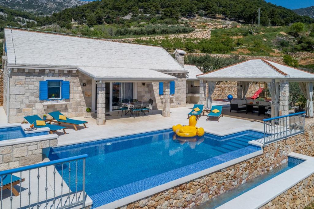 a villa with a swimming pool and a house at Villa Blue Sky in Bol