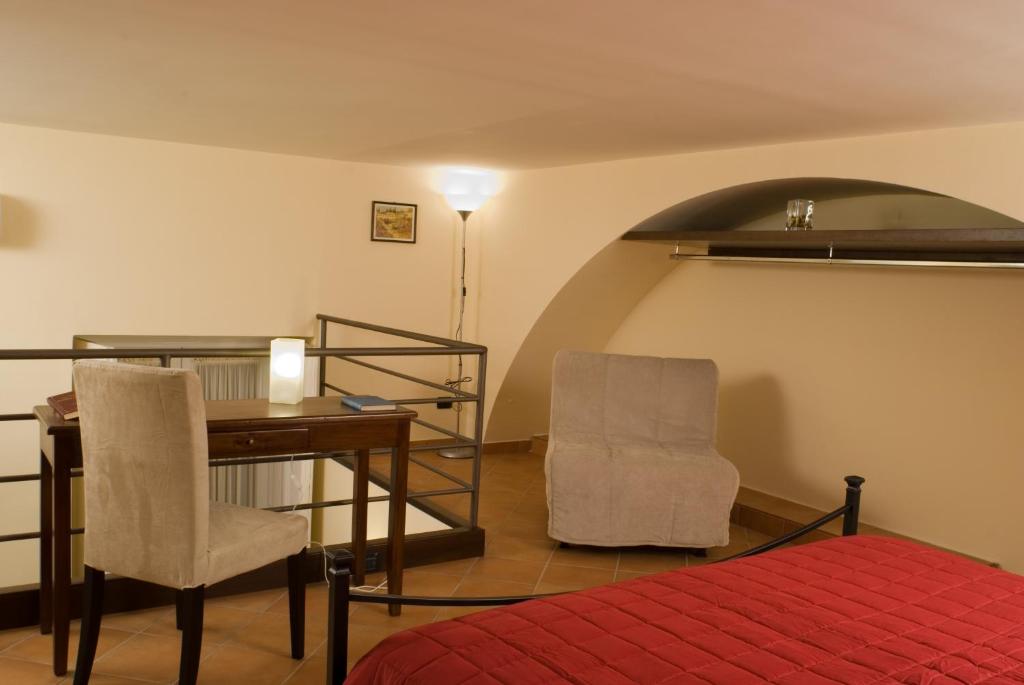 a bedroom with a desk and two chairs and a table at Bed & Breakfast Portanova in Naples