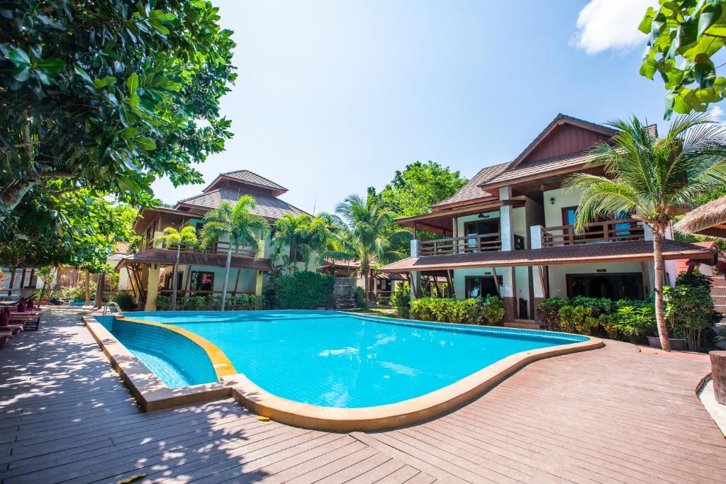 a swimming pool in front of a house at Nice Beach Resort Koh Pha-ngan in Thong Nai Pan Yai