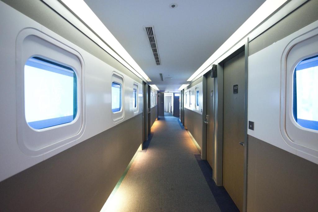 a corridor of a subway train with two windows at Ximen Airline Hotel in Taipei