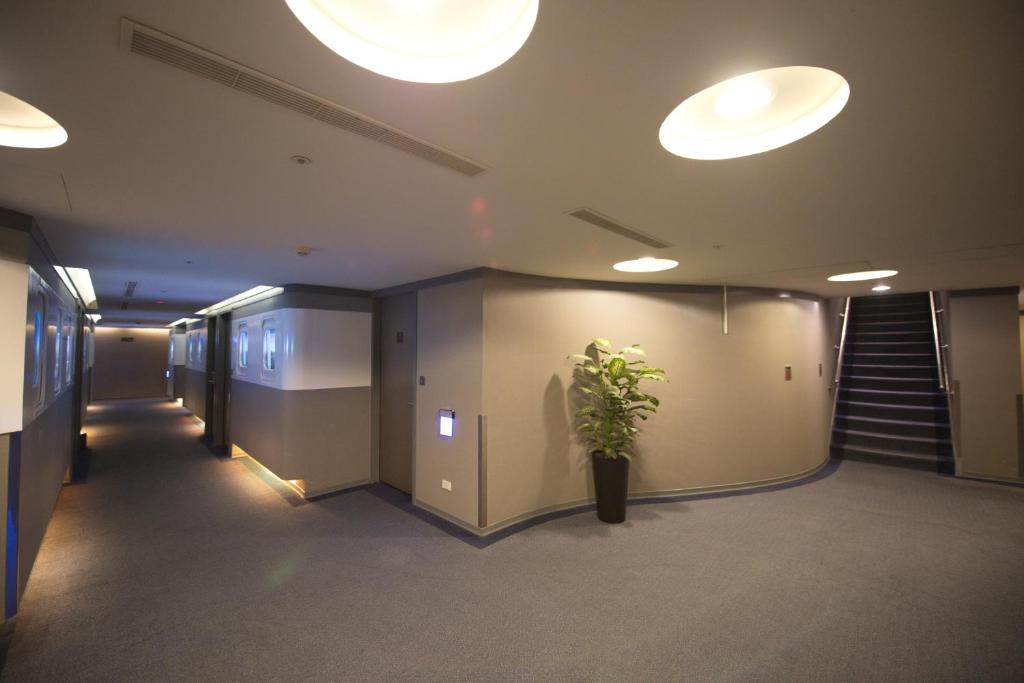 a hallway with a potted plant in a building at Ximen Airline Hotel in Taipei
