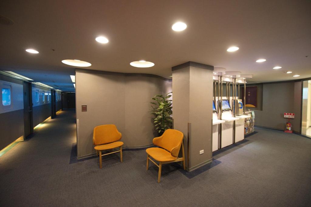 a waiting room with two chairs in an office at Ximen Airline Hotel in Taipei