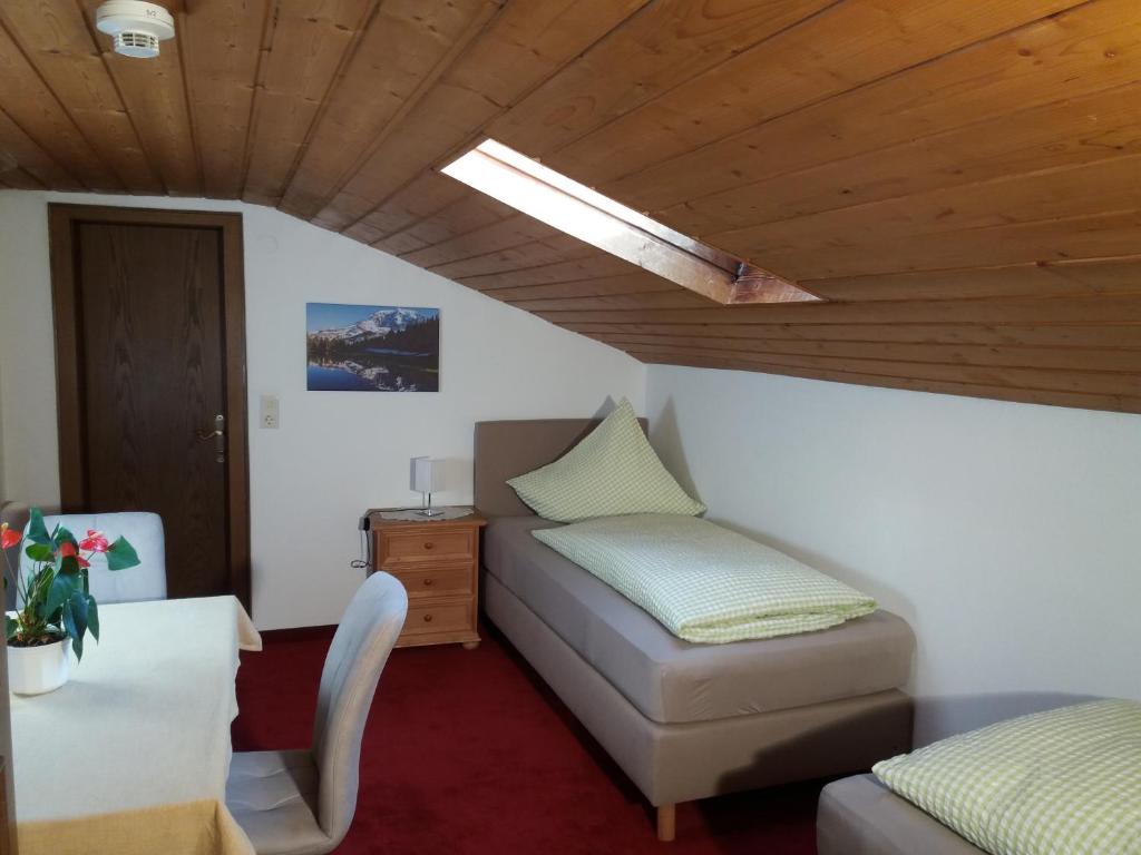 A bed or beds in a room at Pension Sonnenhof