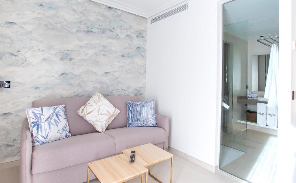 a living room with a couch and a table at Hotel Lava Beach in Puerto del Carmen