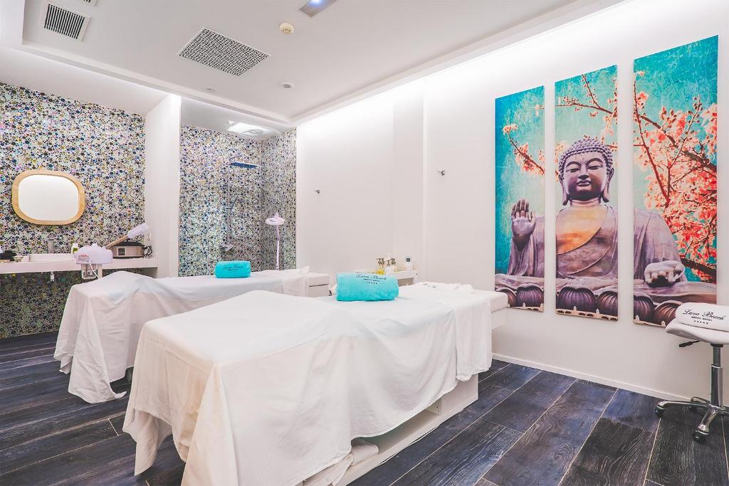 a room with two tables and a large painting on the wall at Hotel Lava Beach in Puerto del Carmen
