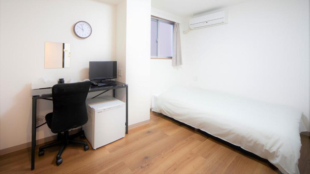Postel nebo postele na pokoji v ubytování Hotel Chuo Bridge
