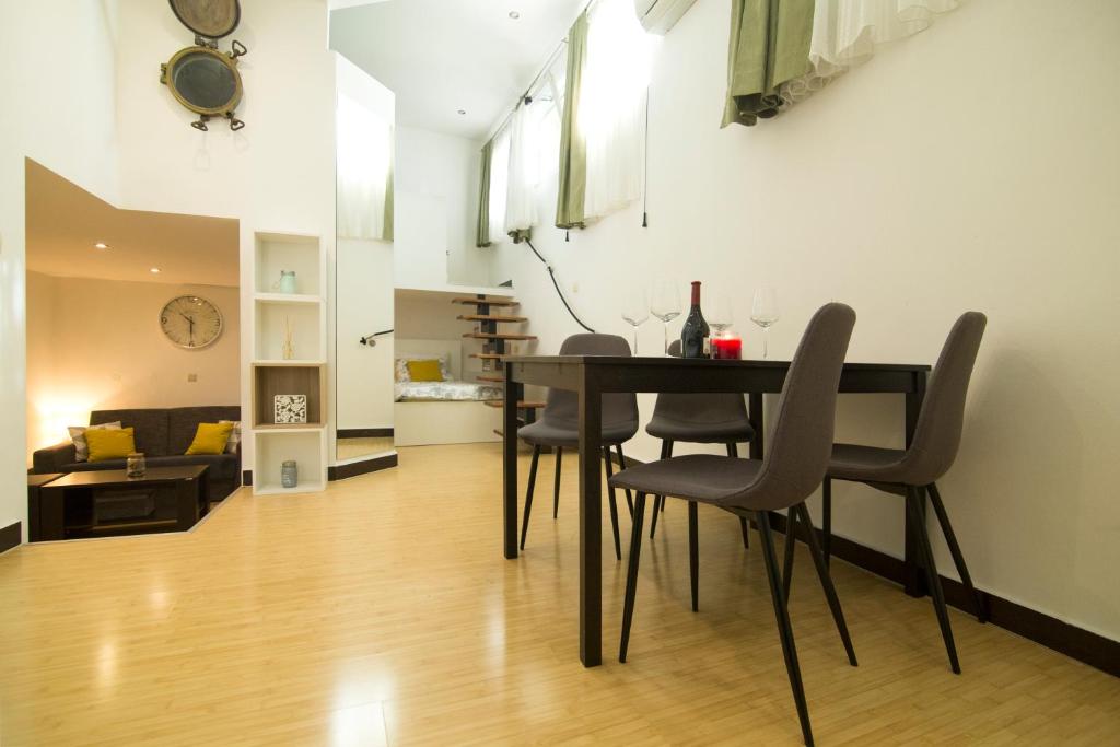a dining room and living room with a table and chairs at Apartment SunDelight in Split