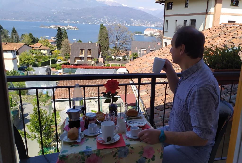 een man aan een tafel met een bord eten bij Sirena in Stresa