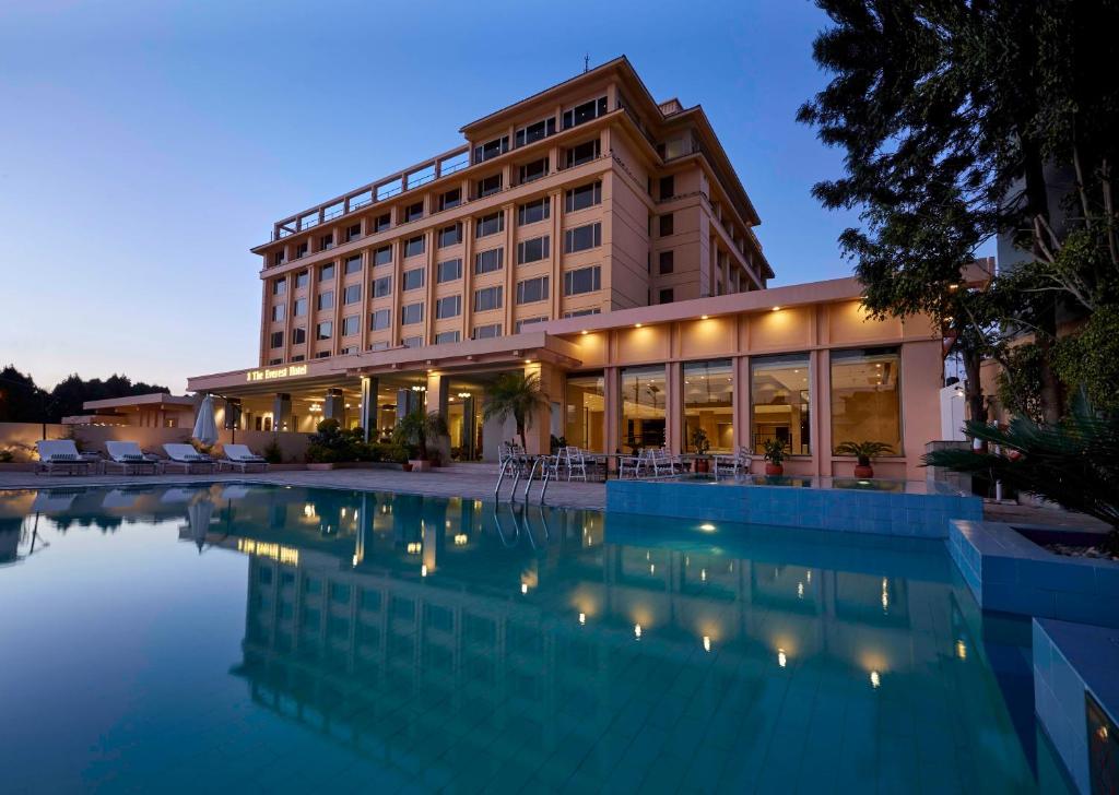 a hotel with a swimming pool in front of a building at The Everest Hotel in Kathmandu